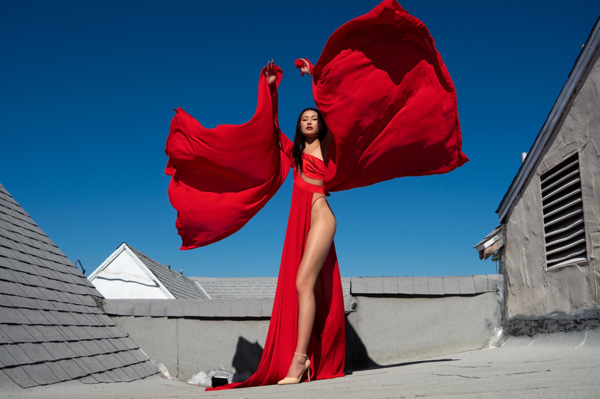 Red fashion against a blue sky by Jeff Linett