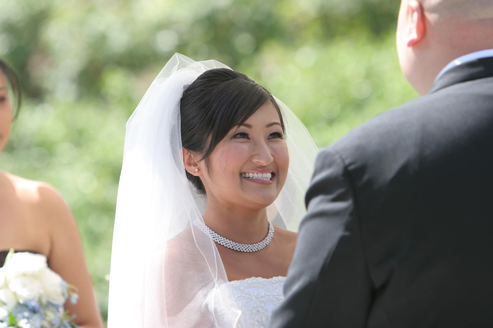 Bride smiling during the ceremony by Jeff Linett